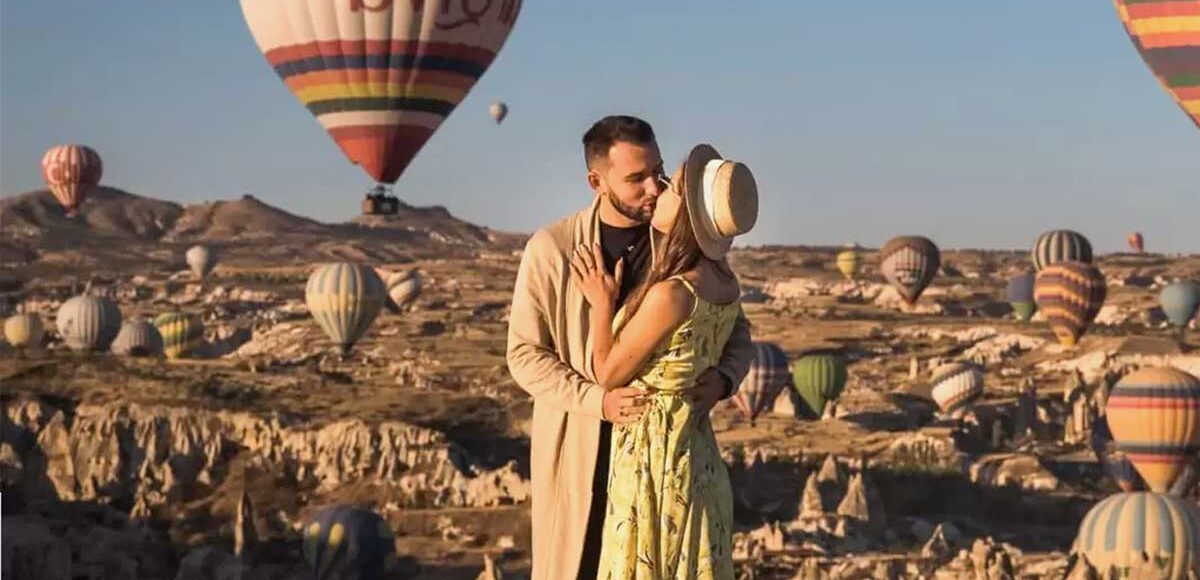 Couple watching Cappadocia balloons at sunrise